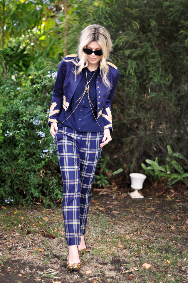 plaid pants, navy jacket with gold embroidery, body harness