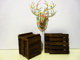 Miniature Typo cardboard stag head, wooden packing  crate and pallets.