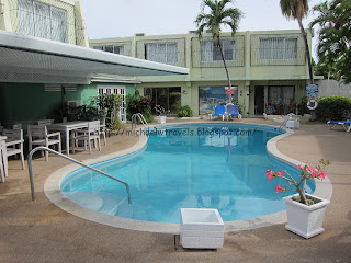 a swimming pool with a deck and chairs