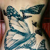 Black butterfly tattoos on back of a lady