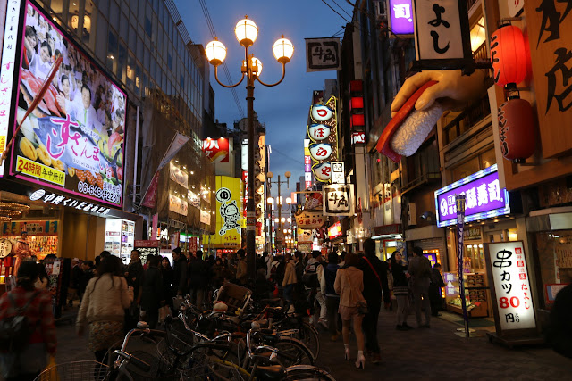 It becomes crowded at night when visitors head to Dotonbori Street for popular okonomiyaki, tetchiri, udon etc. in Osaka, Japan It becomes crowded at night when visitors head to Dotonbori Street for popular okonomiyaki, tetchiri, udon etc. in Osaka, Japan