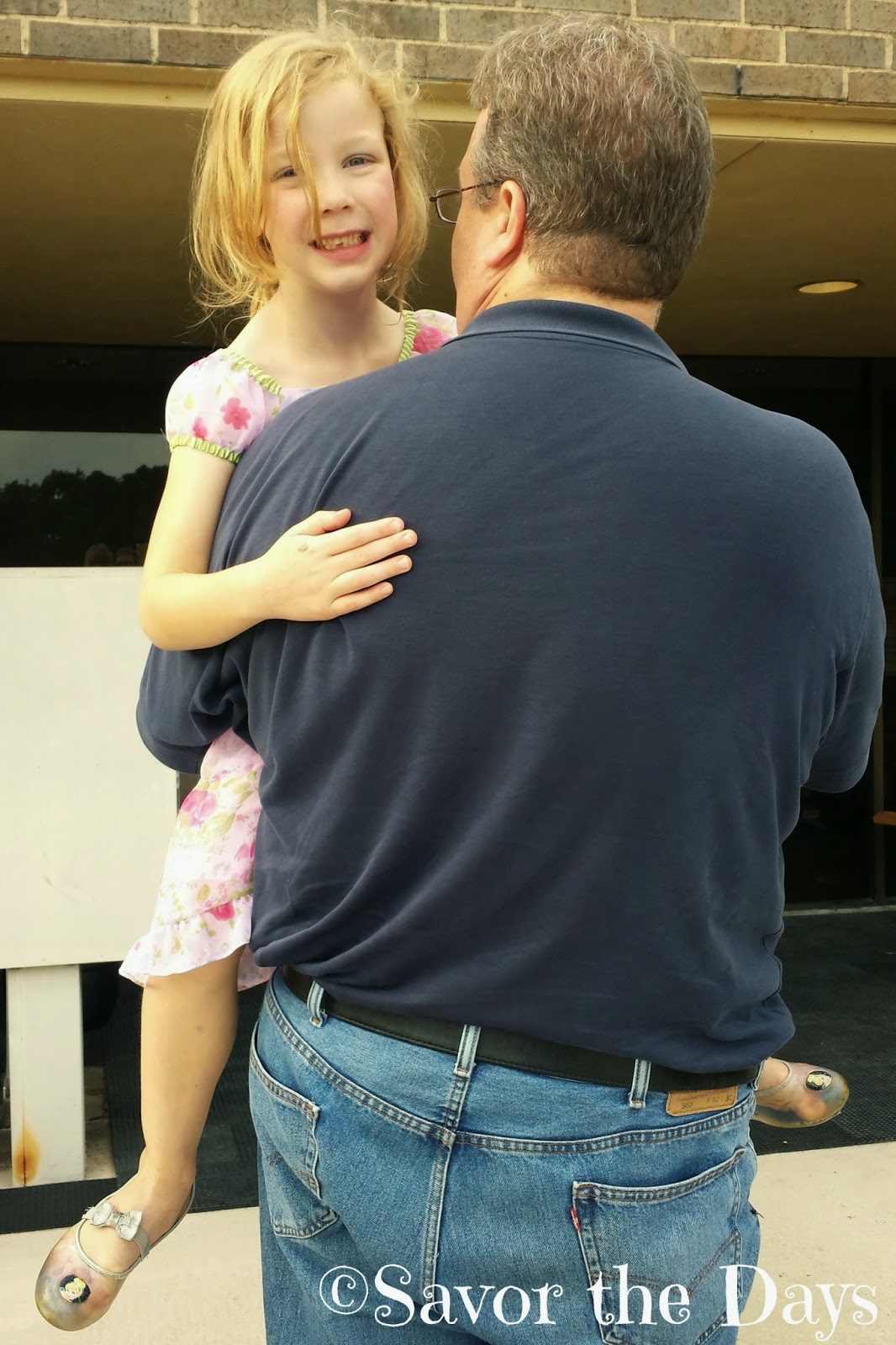 Little Girl Being Carried By Her Daddy