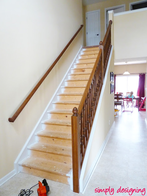 photo of staircase with all carpet and padding removed to show paint overspray on the stair treads