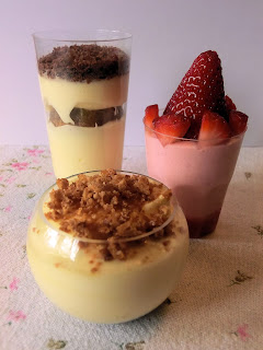 Finger-food dessert shooters trio with mascarpone and amaretto cream, tiramisu coffee mousse and strawberry and whipped cream mousse