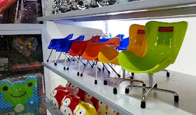 1/6 scale mid-century-modern plastic chairs on display in a shop