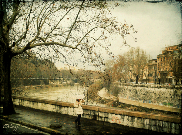 Woman walking along the river in Rome, Italy