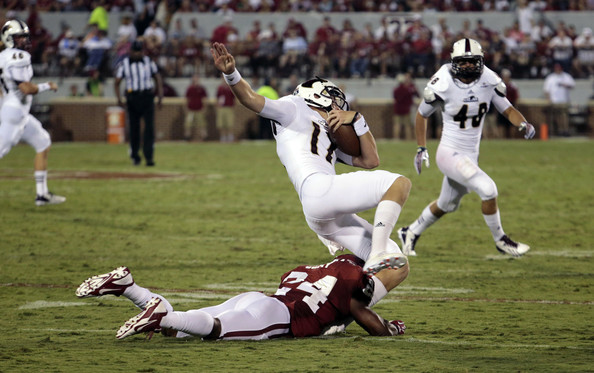 Defensive back Trey Franks #24 of the Oklahoma Sooners tackles kicker Justin Manton #17 of the Louisiana Monroe Warhawks August 31, 2013 at Gaylord Family-Oklahoma Memorial Stadium in Norman, Oklahoma. (August 30, 2013 - Source: Brett Deering/Getty Images North America)