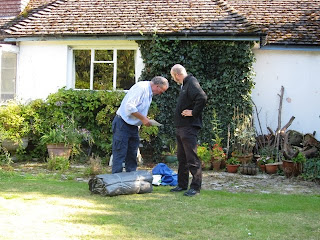 J and Mr A contemplating the rolled up tent