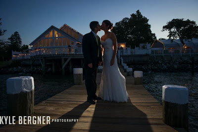 Portrait of the bride and groom at night on the pier