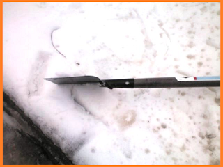 Same ice chisel, but this time from a side view... still sitting on snow.