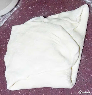 Dough folded completely around the butter plate