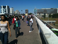 a group of people walking on a bridge