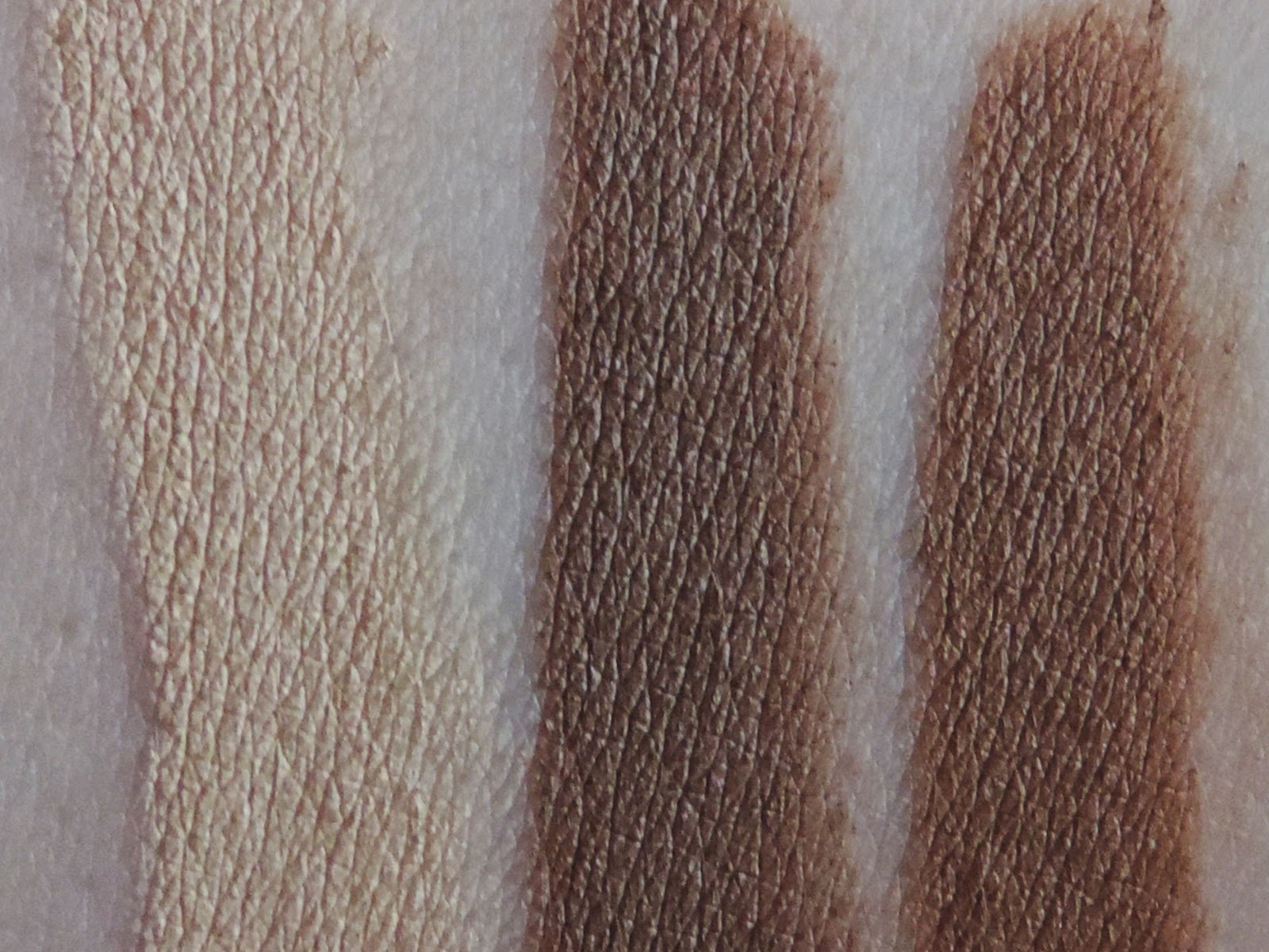 Swatches of Smashbox Step By Step Contour Stick Trio (from left) Highlighter, Contour, Bronze