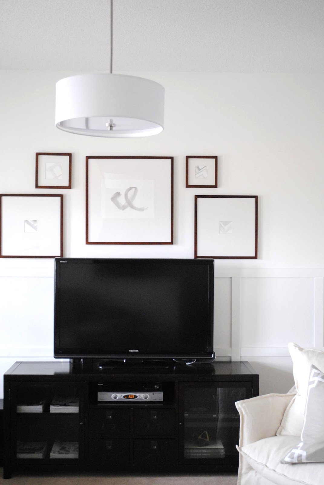 flourish design + style framing a TV with a gallery wall