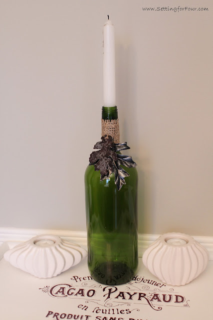 Fall Home Decor Idea: DIY Wine Bottle Candle Holder with painted leaves.