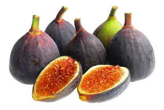 A group of fresh figs, one cut open exposing the sweet flesh.