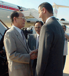 Assad and North Korean ceremonial head of state Kim Yong Nam 