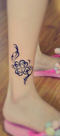 totem style four-leaf clover tattoo on the leg