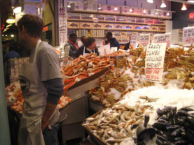 Overflowing display of shellfish, with handmade sign reading Jumbo Grilling Shrimp - Great for the Grill!