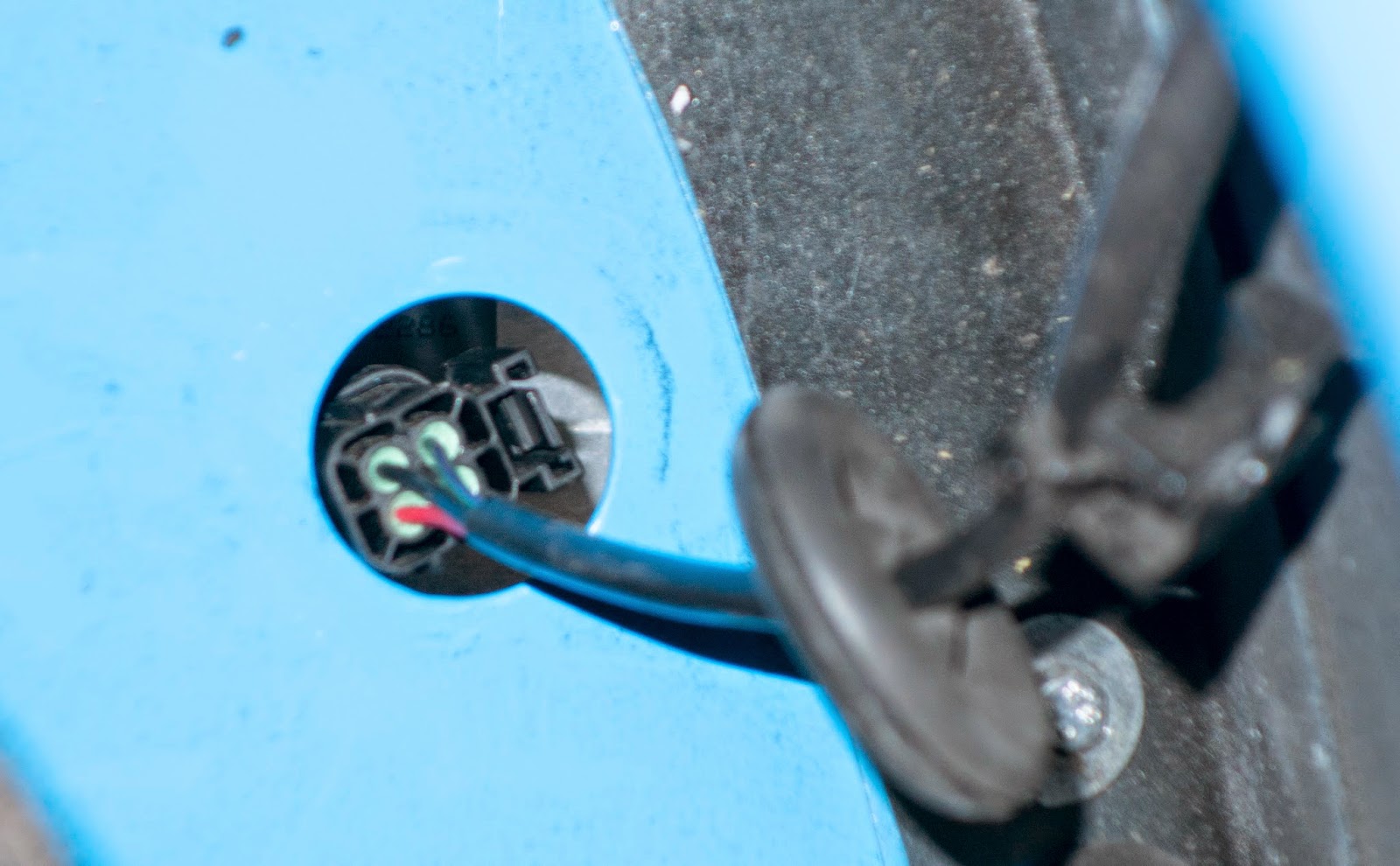 Rubber grommet removed showing light connection block.