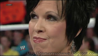 Vickie Guerrero looks at the titantron while AJ does not accept being in a relationship with John Cena on WWE raw held on 05/11/2012