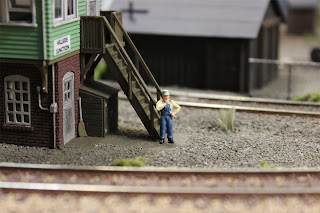 Train mechanic figure standing in front of signal tower