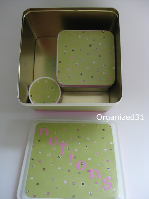 interior view of 2 decorated with green and polka dot paper tins inside larger tin with coordinating decorated lid next to it