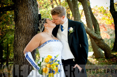 Bride and Groom kissing in the woods