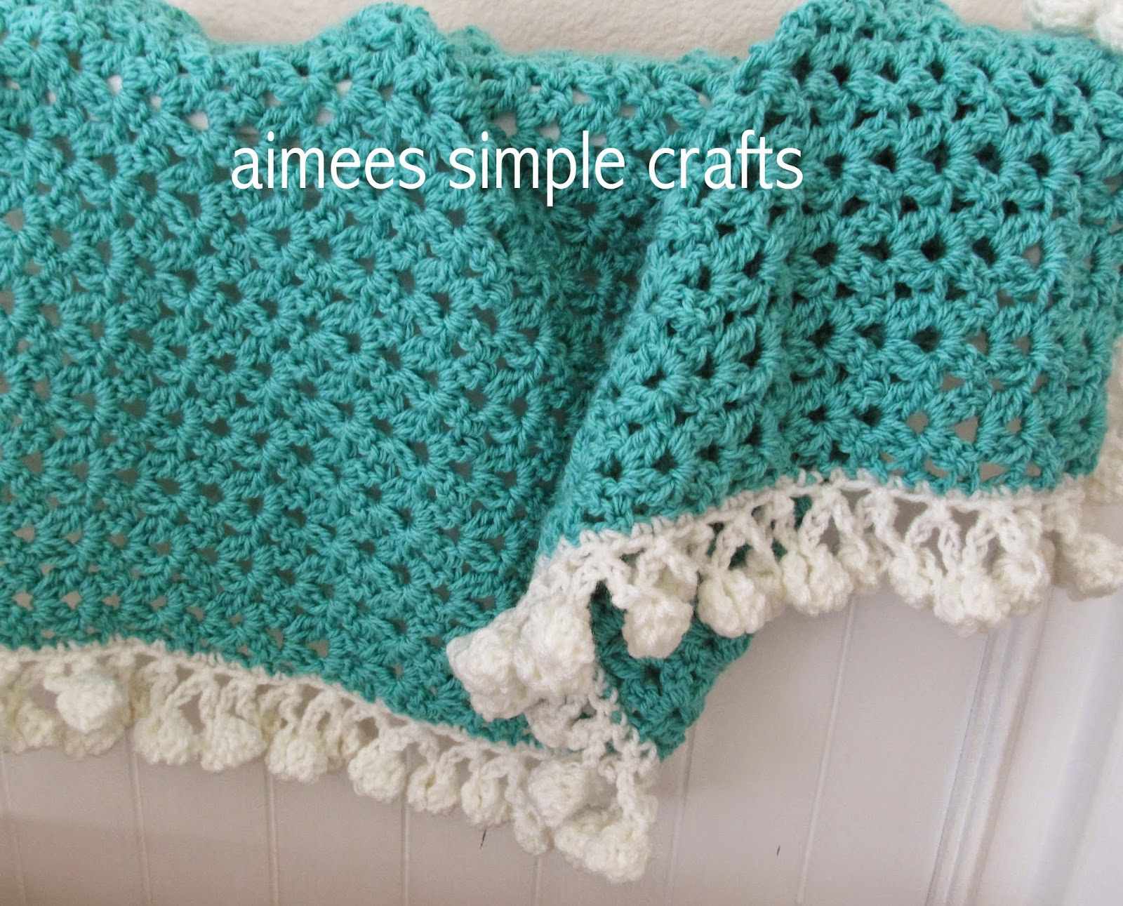 CLUSTER STITCH BABY BLANKET WITH POMPOM EDGING