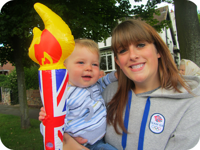 Holding the torch, watching olympic torch go by