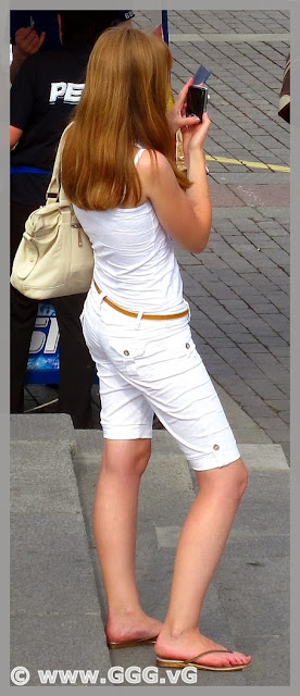 Girl in white breeches on the street