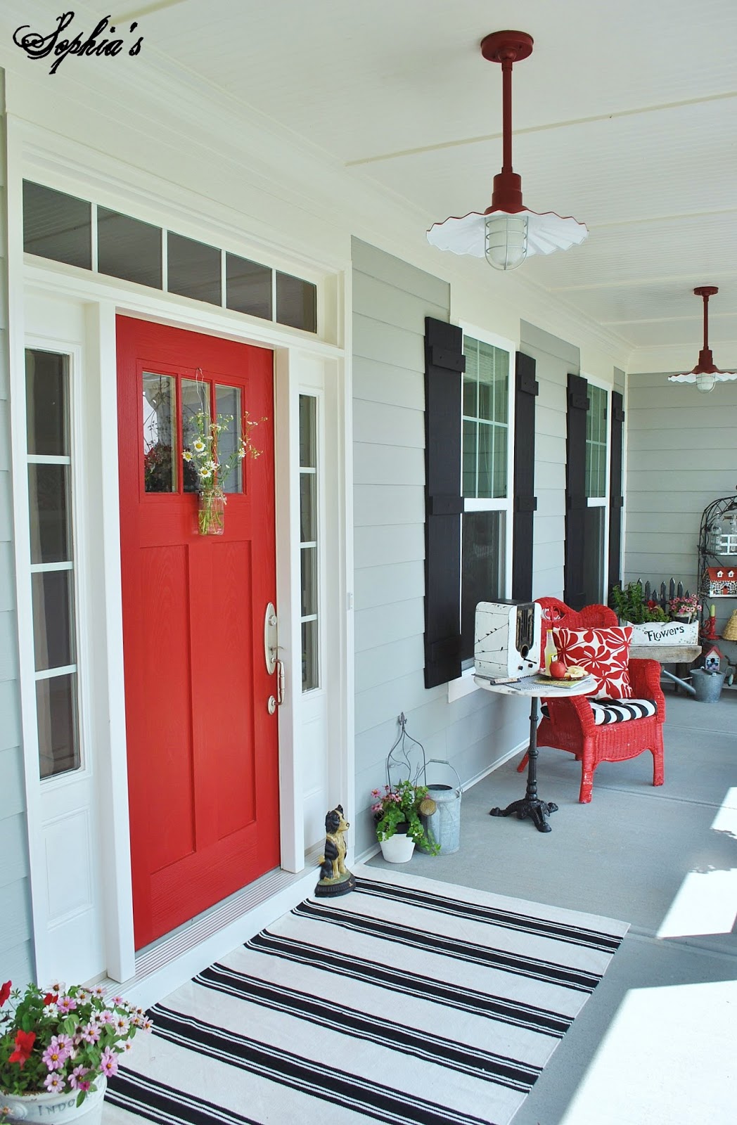 Sophia S Farmhouse Style Front Porch With Pops Of Red