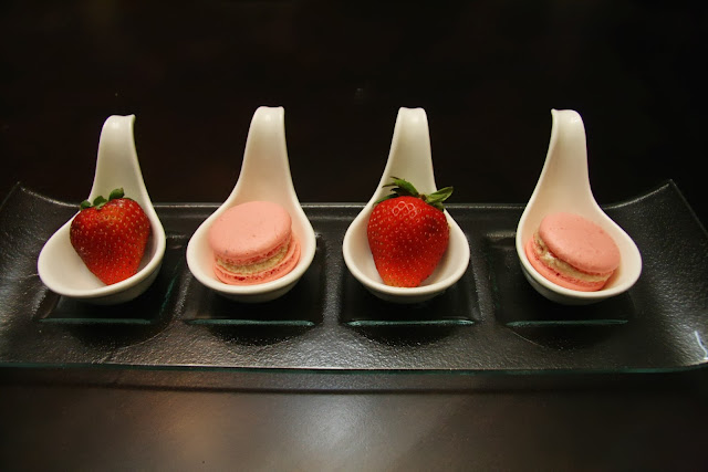 Strawberry Macarons with fresh strawberries on a plate. 