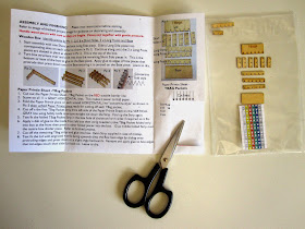 Modern dolls' house miniature tea bag box kit, laid out ready for assembly.