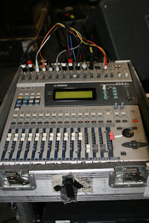The mixer is a Yamaha O1V