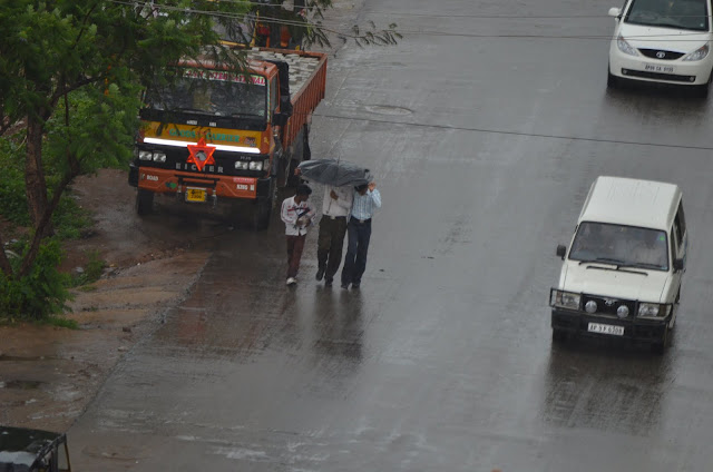 3 boys with umbrella in monsoon