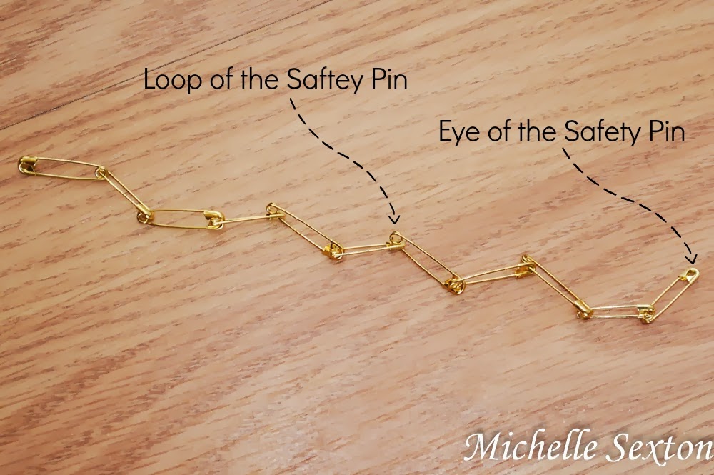 To Make a Safety Pin Bib necklace, start by making a chain of safety pins