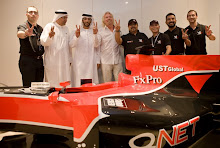 Sheik Ahmed Al Nahyan,QNet's Patron in UAE poses with QNet team & Richard Branson with replica car