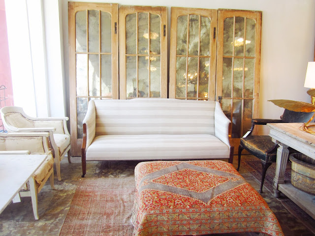 Old mirrored doors are part of a living room display in Brenda Antin