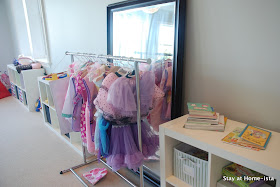 dress up clothes hung on a rolling rack for storage