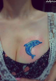a blue dolphin tattoo on the chest