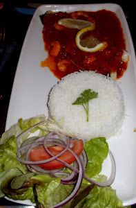 Sea Bass Fillet Served with a Prawn and Provence sauce with a timbale of Rice and a Garnish of Salad.