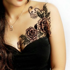 Pretty wild flower tattoo on breast and shoulder