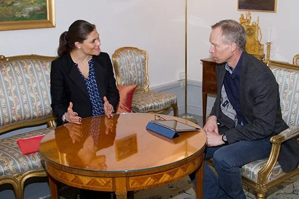 Crown Princess Victoria of Sweden met with Johan Fredrik Rockström who is a Professor of Environmental Science at Stockholm University, The Crown Princess wore BY MALENE BIRGER blacak Coat and MAYLA printed Dress