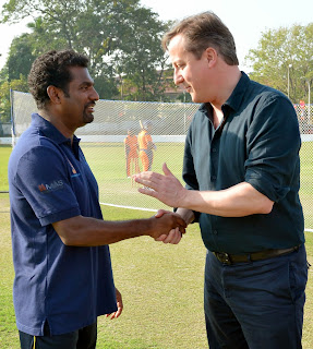 British Prime Minister David Cameron thanks Sri Lankan spin bowler Muttaiah Muralitharan (L) after trying his hand at batting during the former's visit to the Colombo Cricket Club in on November 16, 2013. Britain's Prime Minister David Cameron made a historic visit to Sri Lanka's former warzone, stealing the spotlight from a Commonwealth summit after the host, President Mahinda Rajapakse, warned against passing judgement on his country's past