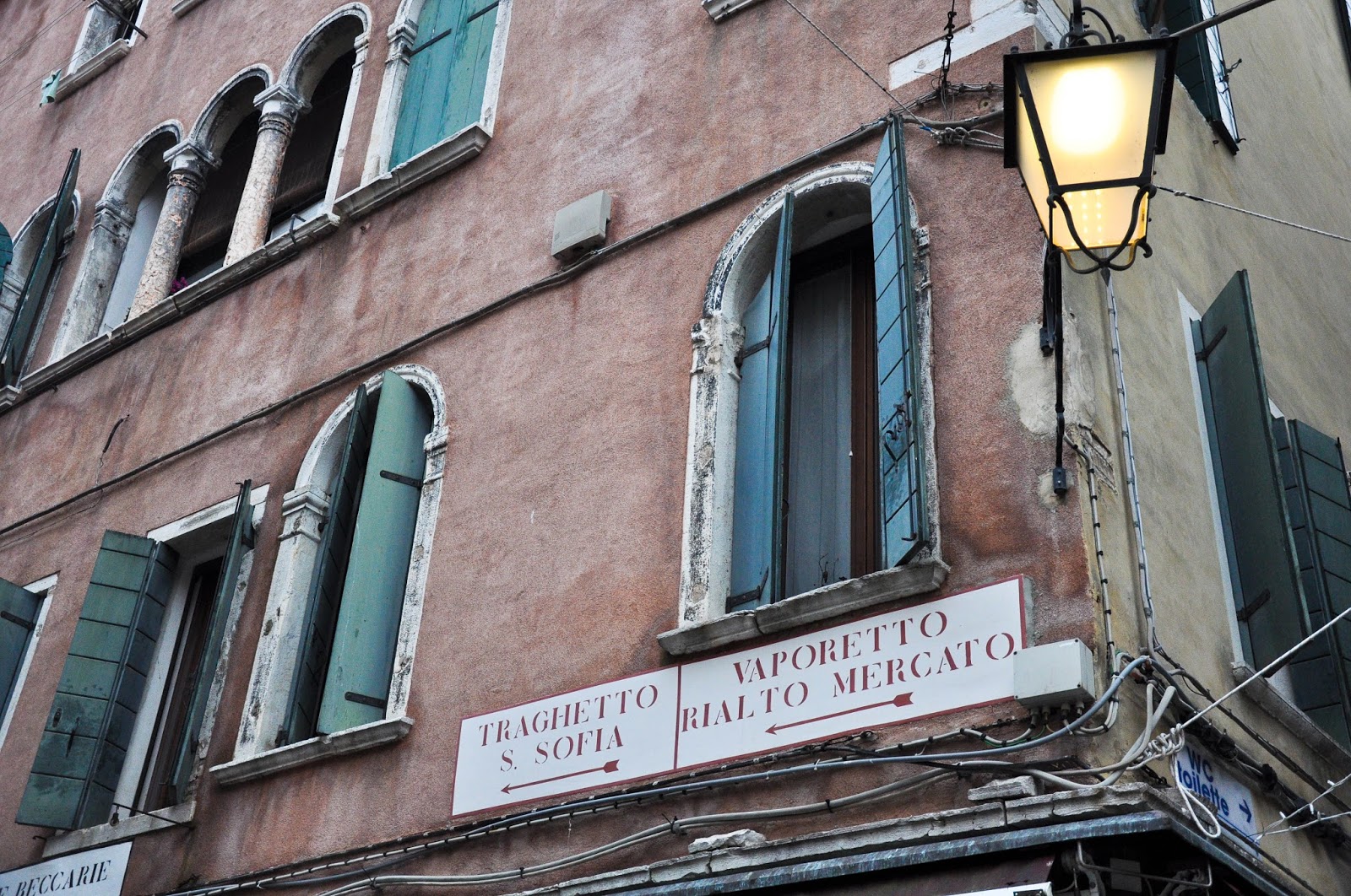 Sign pointing to a traghetto stop, Venice, Italy