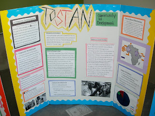 One of three group posters about Tostan