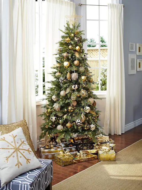 Gold ornaments on narrow Christmas tree. Gold wrapping paper | CANVAS Christmas Collection