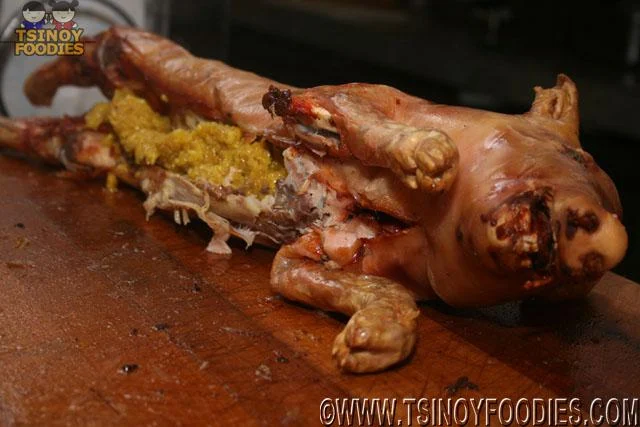whole baby lechon with stuffed curried rice (biringhe)  