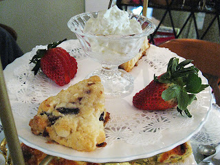 Chocolate cherry scones served with sliced strawberries and clotted cream